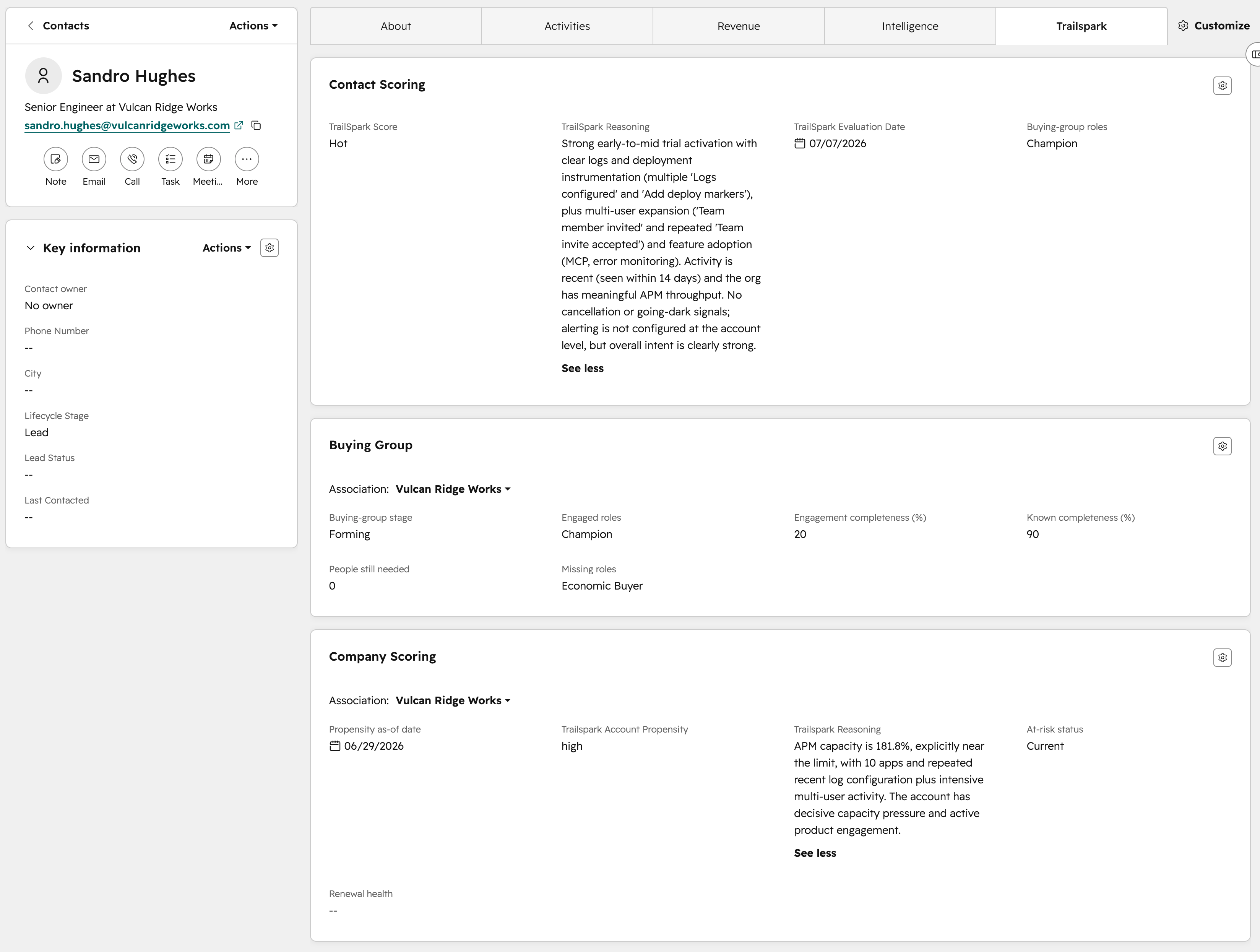A HubSpot contact record for Sandro Hughes, Senior Engineer at Vulcan Ridge Works, open on a custom Trailspark tab. A Contact Scoring card shows a Hot score and a written reason describing strong early-to-mid trial activation with logs and deployment instrumentation, multi-user expansion through team invitations, and feature adoption including MCP and error monitoring, noting activity within the last 14 days and no cancellation signals. A Buying Group card shows stage Forming, engaged role Champion, engagement completeness 20 percent, known completeness 90 percent, and missing role Economic Buyer. A Company Scoring card below shows account propensity high with its own separate reason about APM capacity.